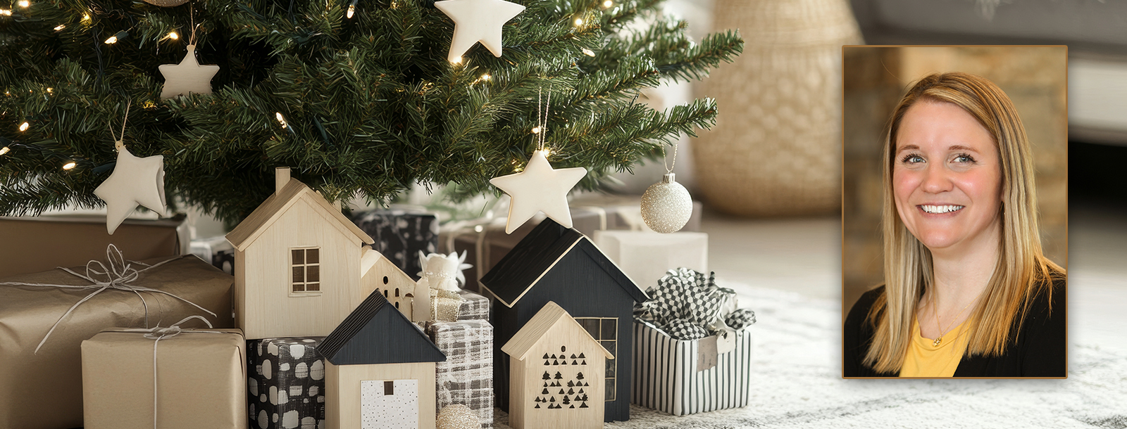 Wooden houses and presents under a Christmas tree.